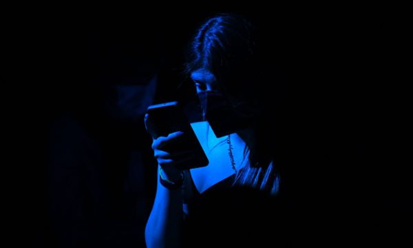 Teen looks at her phone